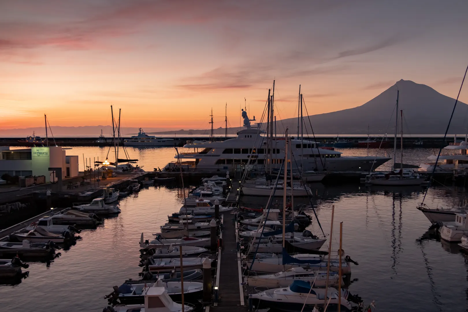 Horta marina at sunrise on Faial with boats moored in the foreground